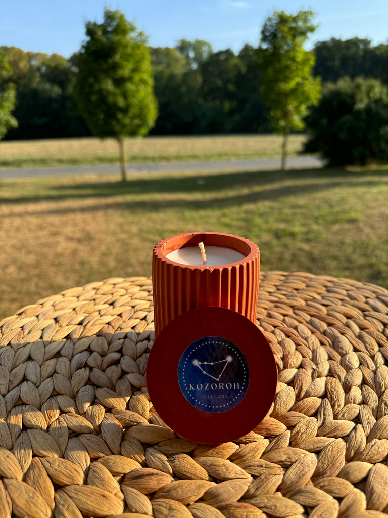 Handmande candle with the Capricorn zodiac sign, orange color, made from soy wax.